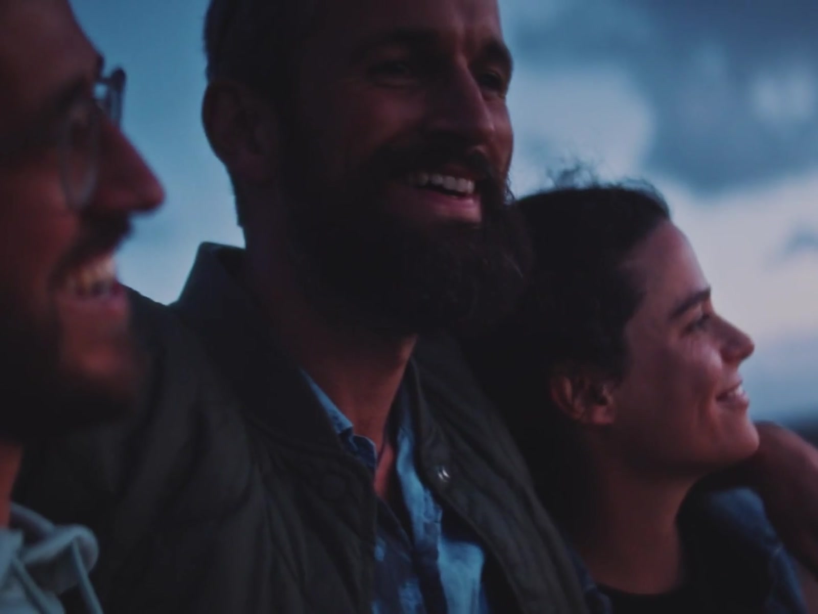 Three friends laughing together on a night out