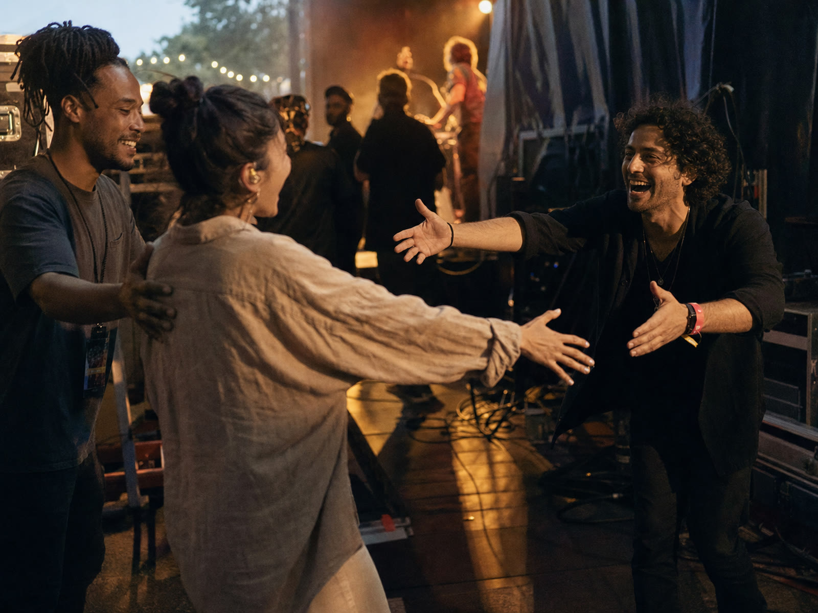 A coordinator making an enthusiastic backstage introduction at a live event