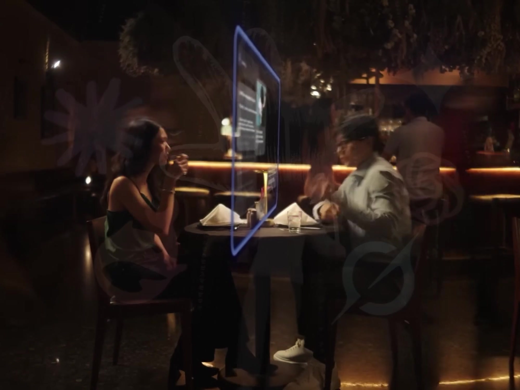 Two people talking across a table with a glowing connection between them